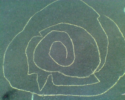 a child's chalk art labyrinth 