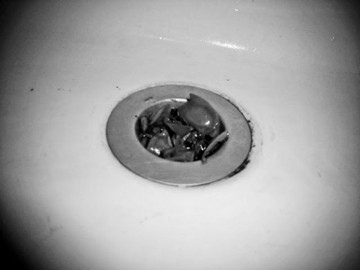 Sink stopper with food debris.