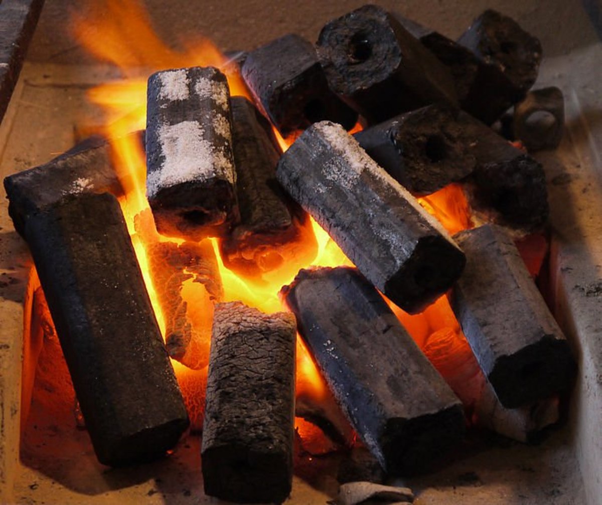 How to Make Charcoal Briquettes - Charcoal Briquettes Burning. Image credit:DryPot, Wikimedia Commons. 