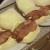 Lay the bacon gently onto the bread baps, if you don't like bacon poking out of the bap fold it and tuck it into bed!