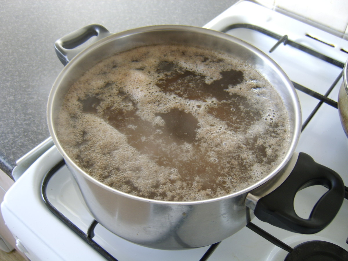 Impurities will form on the top of your beef stock, especially in the earlier stages of simmering