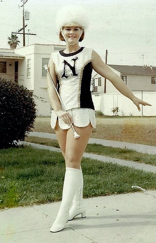 THE CLASSIC MAJORETTE WITH HEADDRESS. NO PEP RALLY OR PARADE WOULD BE COMPLETE WITHOUT A LEAD MAJORETTE.