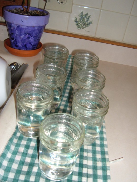 Wash and rinse jelly jars. Set them on a towel and fill with boiling water.