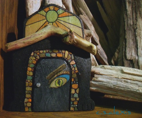Mixed media artwork shows in this miniature Fairy Door from Adrift Art Studio shop Walk Softly13. A combination of wood burning, acrylic paint, graphic art, driftwood, jewelry findings and magical powers are found in this wonderful piece. 