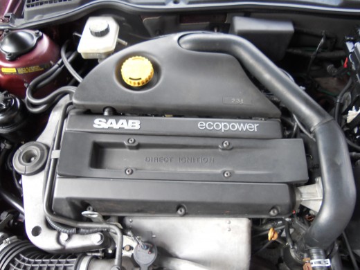 Early model Saab 9-5 engine bay. Note the exhaust manifold cover at front of motor.