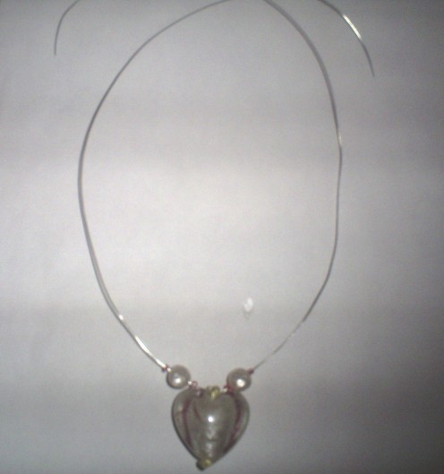 Slip the heart pendant on the beading wire you will be using for your necklace.