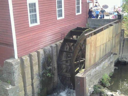 The water wheel that turns the grist mill machinery.