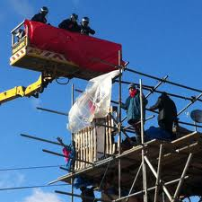 Police reach the heights in a cherry picker to arrest demonstrators at Dale Farm Oct 19