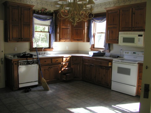 Updated but well done kitchen with solid knotty pine doors and cabinets, beautiful tile floor.