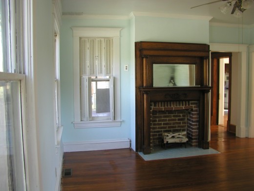 another view of mantle and cute little side window with louvered window covwering