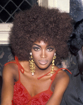 Naomi Campbell wearing a Afro Wig