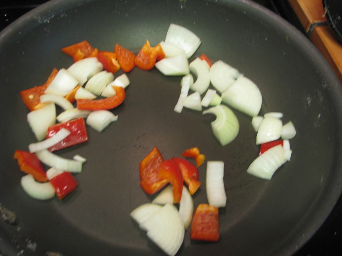 Fry onions and red pepper. Sauté onion and bell pepper for about 3 minutes or until just soft.  .