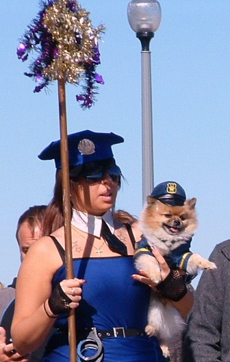 In response to Mason Cooley's, "Costumes tell a story" here's a fairy tale about this picture: "Curvaceous police woman falls in puppy love at the Sea Witch Festival in Rehoboth Beach and they live happily ever after." 