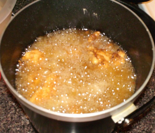 Chicken strips in deep fryer.