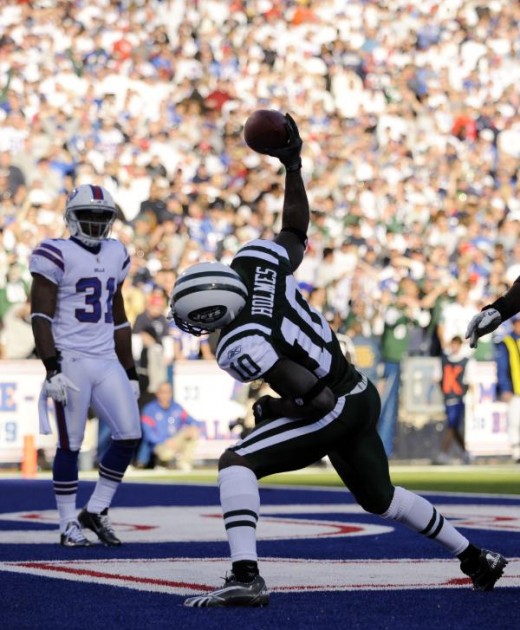 New York Jets' Santonio Holmes (10) celebrates his touch down in front of Buffalo Bills' Jairus Byrd (31) during the second half of an NFL football game in Orchard Park, N.Y., Sunday, Nov. 6, 2011. The Jets won 27-11. (AP Photo/Gary Wiepert)