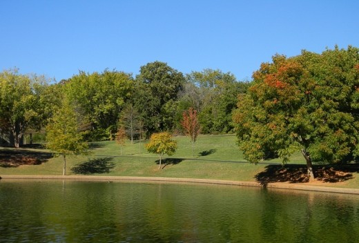 Looking across quiet green water the sapphire sky contrasts with touches of Autumn's paintbrush on a (rarely) windless day. 