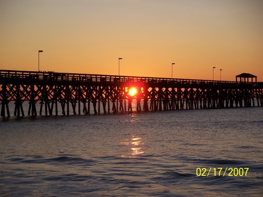 PICTURE OF SUNRISE AT MYRTLE BEACH THROUGH A PIER