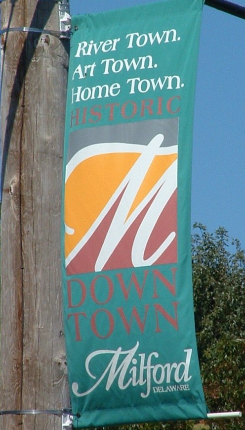 Milford, DE, is proud to be known as a river town, art town, home town with a historic down town. Flags with this inscription grace the historic streets and riverwalk. 