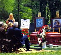 SOME FUNERALS HAVE PICTURES OF THE DECEASED ON DISPLAY AS A GESTURE OF RESPECT FOR THE ONE WHOM HAS PASSED.
