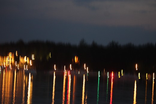 The reflection of the lights of the boats awaiting the fireworks.