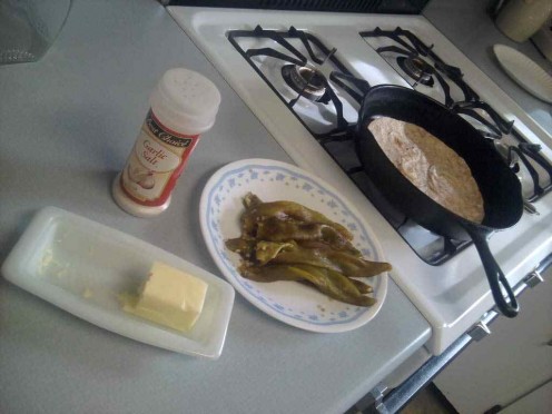 Heat a flour tortilla, spread it with butter, add chiles and garlic salt!  Yummmm!