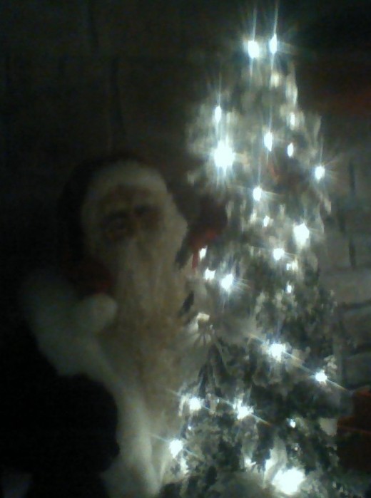 Father Christmas by a glowing tree