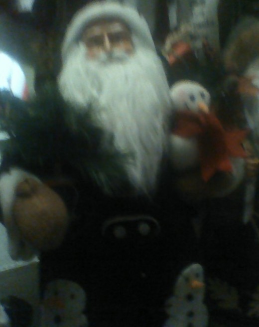 Father Christmas with snow people in his arms