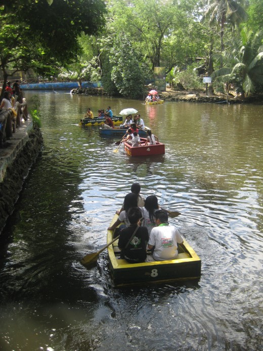 The man-made lake at Manila Zoo with tourists having boat rides