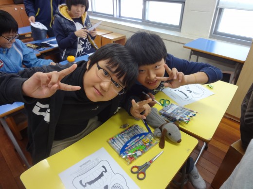Two students making their masks.