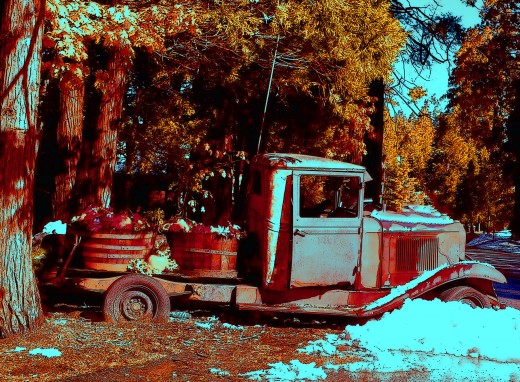 a rusted old truck with autumn pumpkins is an unusual autumn photo, made more interesting by the contrast of the snow..