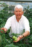 Dr. Charles Arntzen displays some of his vaccine-carrying tomatoes
