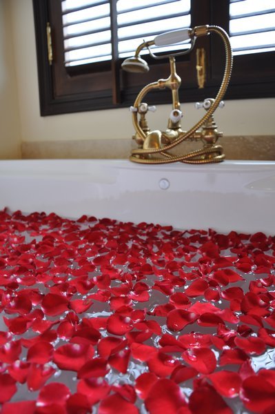 A lavish bath with rose petals