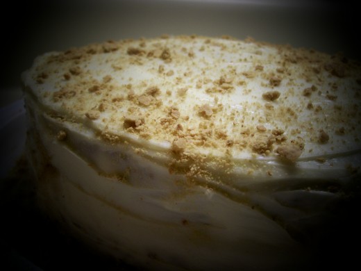 Graham Cracker Cake with cream cheese icing topped with some graham cracker crumbs. You can also use ground walnuts to garnish instead of the grahams.
