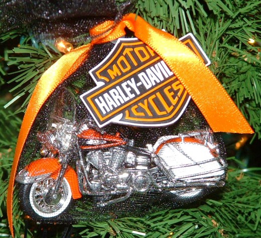 Other Harley Davidson models are wrapped in black netting tied with orange bows. 