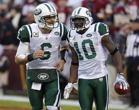New York Jets wide receiver Santonio Holmes, right, runs off the field with quarterback Mark Sanchez after scoring a touchdown on a pass from Sanchez during the second half of an NFL football game against the Washington Redsk insin Landover, Md., Sun