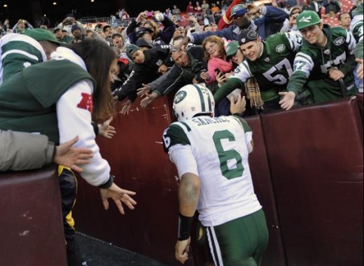 New York Jets quarterback Mark Sanchez is congratulated by fans as he leaves the (AP Photo/Nick Wass)