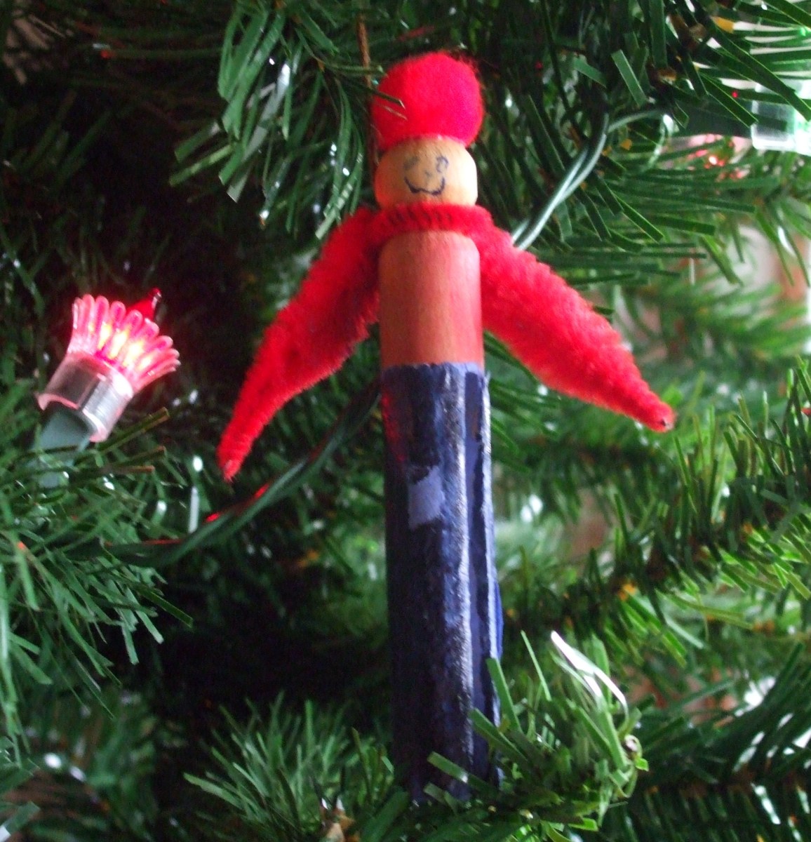 Hanging on the Christmas tree, this clothespin ornament keeps watch.