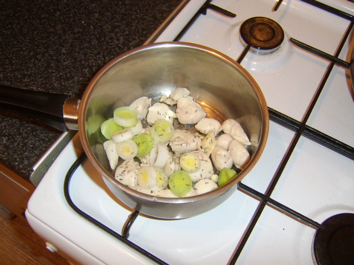 Sauteeing the chicken and leek in oil