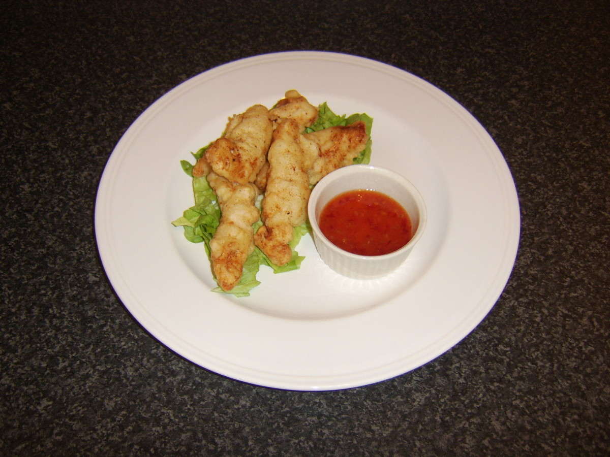 Chicken dippers served on a bed of shredded lettuce with Thai sweet chilli dipping sauce in a ramekin
