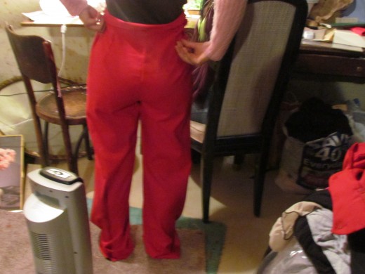 Jaleesa, poses the rear of these precious red pants. She is excited about the results.