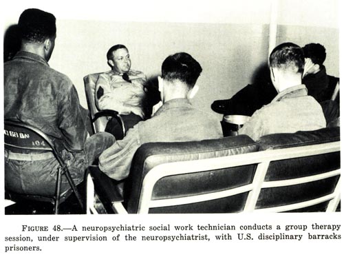 A neuropsychiatric social work technician conducts a group therapy session, with U.S. disciplinary barracks prisoners