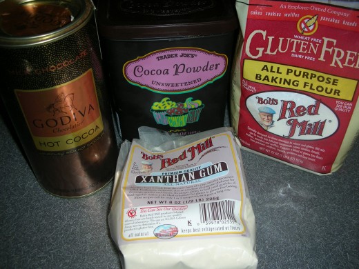 From left to right: Godiva hot chocolate, cocoa powder, xanthum gum, gluten free flour
