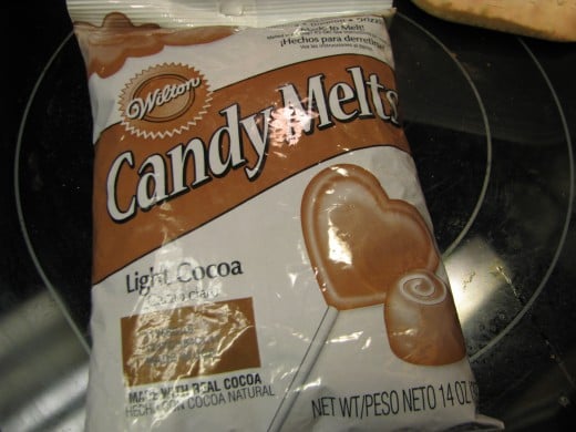 Step Two:  Melt the Candy Melts or Chocolate Bark.   Melt right in the bag or in a bowl one minute on high.  Then knead the bag  (or stir bowl) until everything is melted. Chocolate chips work too, althoug Nestle's don't melt as well as other brands 