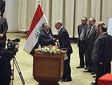 Iraq's President Jalal Talabani shakes hands with newly elected speaker Usama al-Nujayfi on 11 November.2010