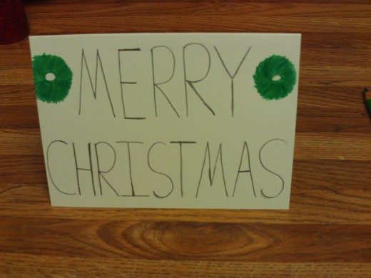 Another Christmas card with two wreaths on it.