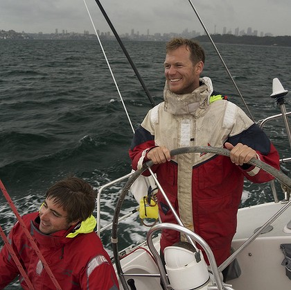 Skipper John Naylor at the helm during a harbour storm. Photo: Mark Dando Read more: http://www.smh.com.au/sport/dark-and-stormy-getting-ready-for-yachtings-everest-20111220-1p3he.html#ixzz1haOEpVqP 