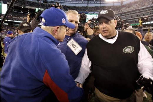 New York Jets head coach Rex Ryan, right, shakes hands with New York Giants head coach Tom Coughlin Dec. 24, 2011 Giants won 29-14. (AP Photo/Julio Cortez)