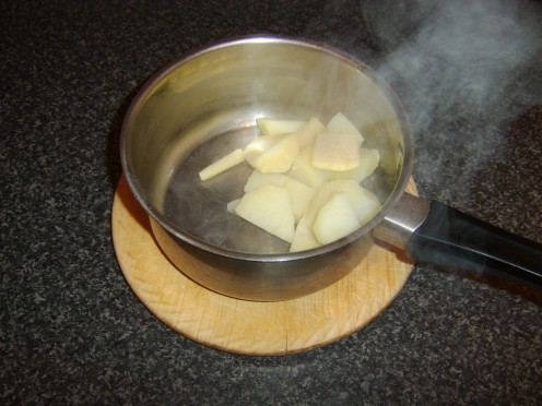 Butter and white pepper are added to the drained potatoes and parsnips
