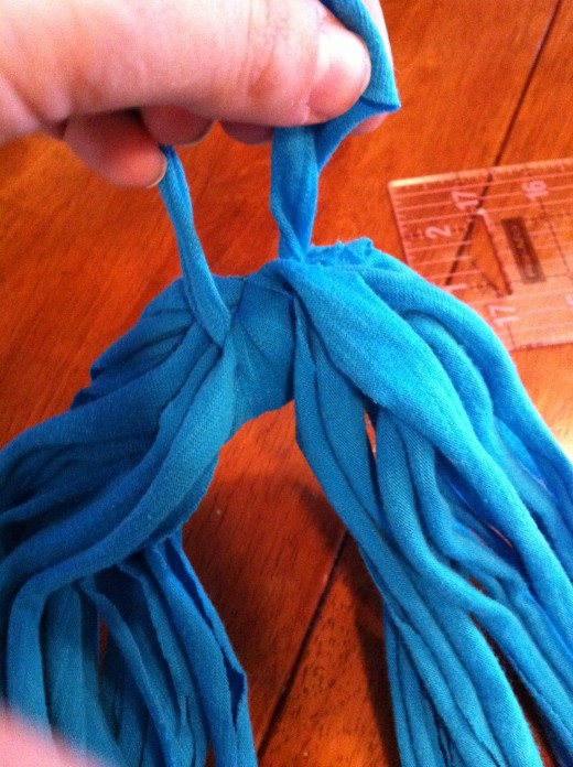 Tie one of the strips around the seams and double knot. Tuck the leftover under. 
