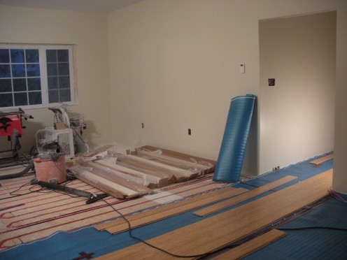 In the process of installing the floor. Here we centered boards down the hall into the great room for visual interest and the desire not to use thresholds throughout the home.
